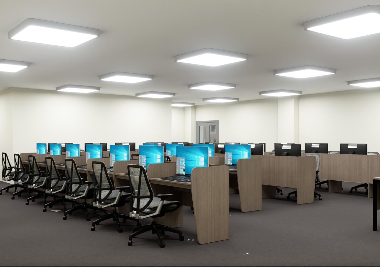 Computer lab with wooden desks and monitors